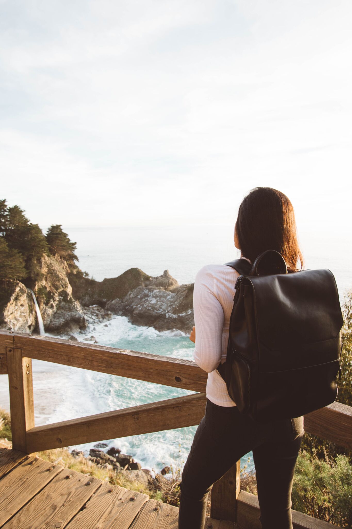  woman with a black Native Soul Trading Co bag packed to the brim using the best packing strategies