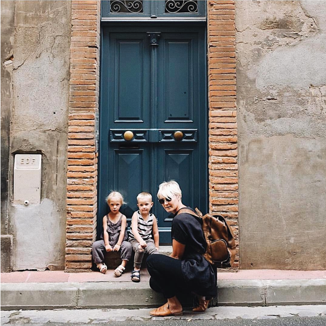 image of a young mom and her two kids out and about with her minimalist diaper bag