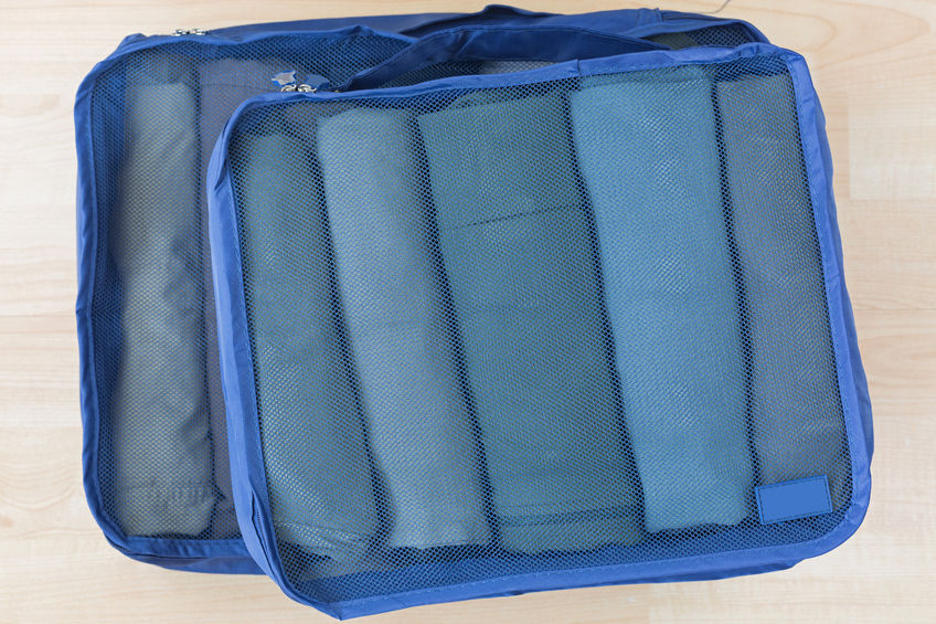 Cubed mesh bags with rolled clothes inside to make packing easier and more efficient